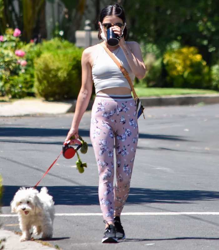 Lucy Hale walks her dog Elvis wearing floral Beyond Yoga "Olympus" high-waisted leggings