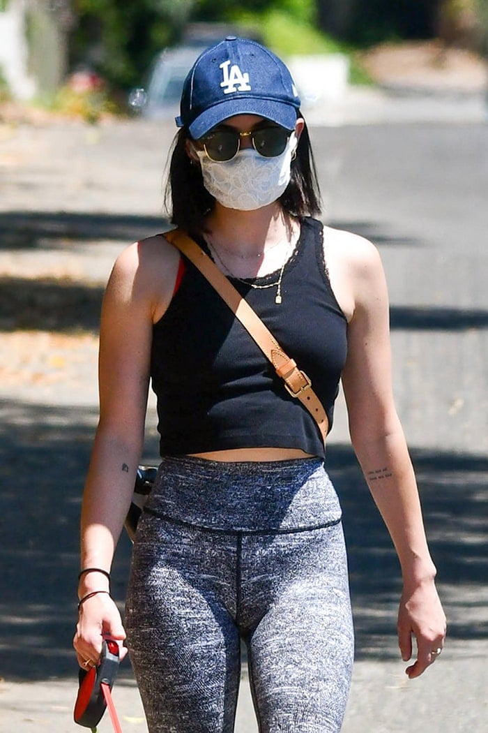 Lucy Hale finishes off her sporty look with Louis Vuitton bumbag and LA Dodgers cap