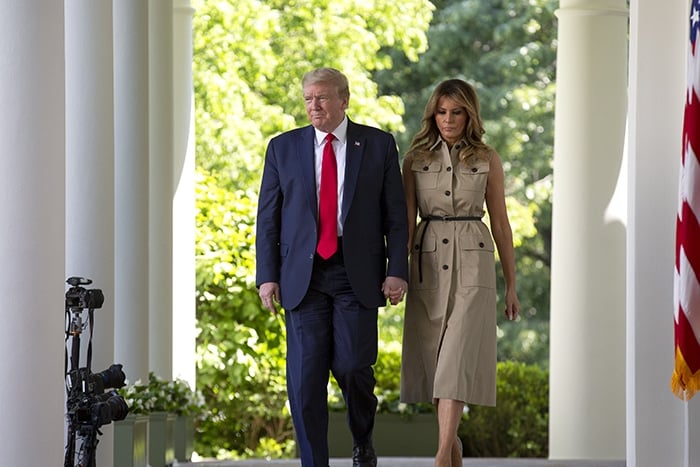 President Donald Trump and First Lady Melania Trump hold hands before taking the podium during the National Day of Prayer on May 7, 2020