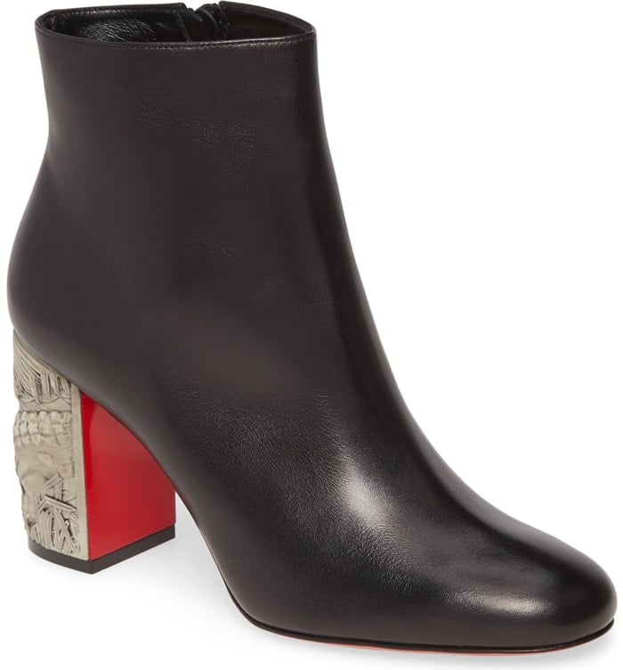 A beautifully carved block heel brings undeniable artistry to an Italian-crafted bootie in smooth, supple leather