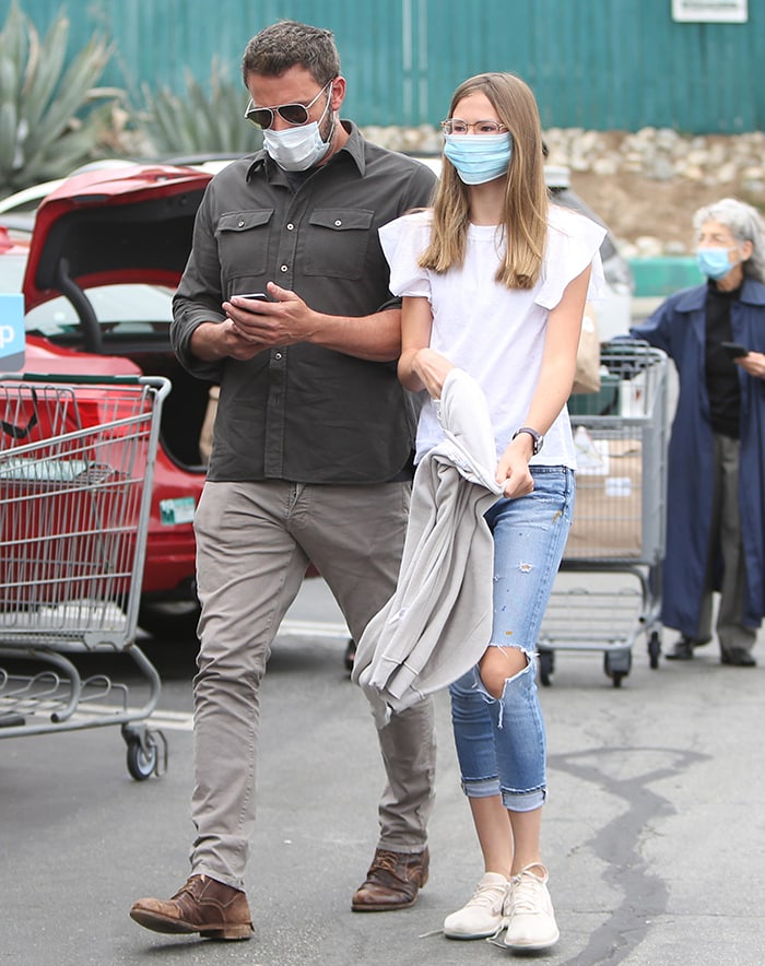 Ben Affleck opts for his signature cool dad outfit while his daughter Violet wears a white blouse with ripped jeans and sneakers