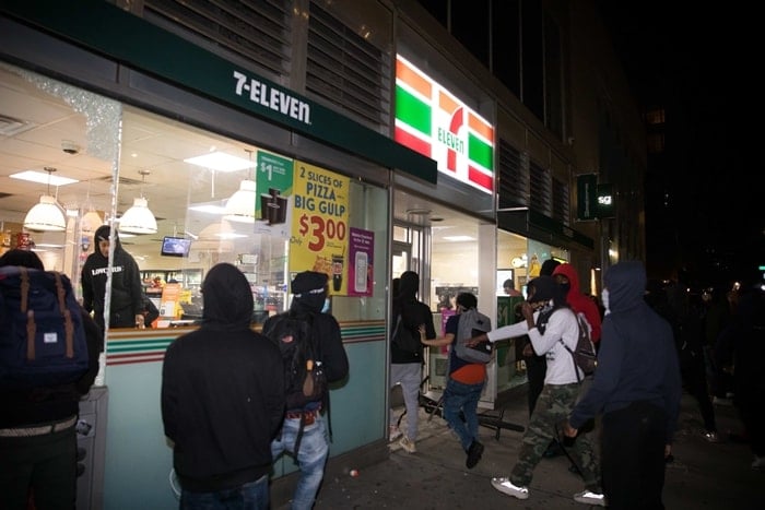 Demonstrators break into a 7-Eleven store during a protest over the death of George Floyd in New York