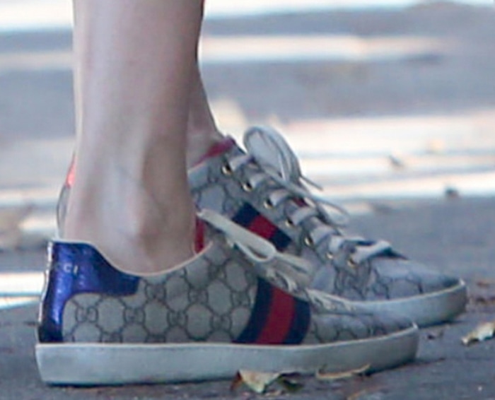 The classic GG Supreme logo shines through on Laura Dern's sneakers featuring web stripes at the sides and genuine snakeskin heel counters in house colors