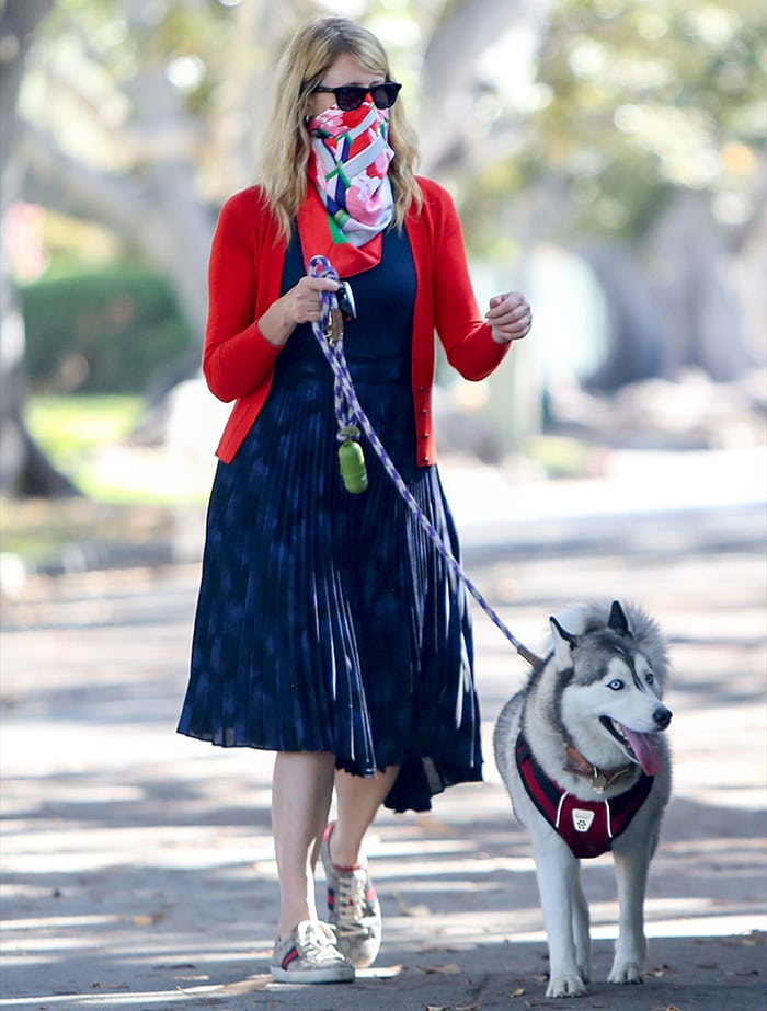 Laura looks chic and summery in her navy dress and red cardigan