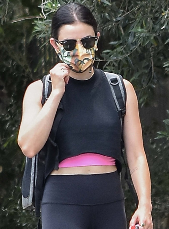 Lucy Hale rocks a black Inspire crop from Alo Yoga and Ray-Ban Rb3016 Clubmaster sunglasses
