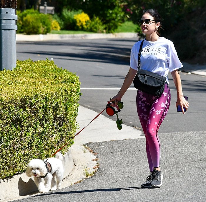 Lucy Hale wears cherry blossom leggings with a white tee