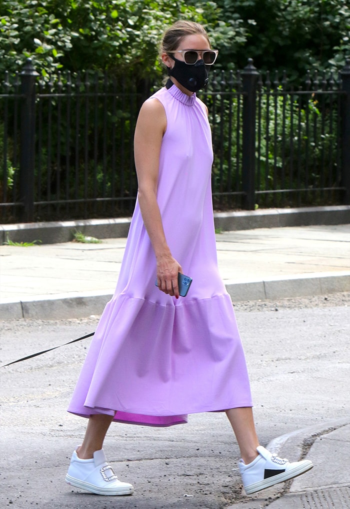 Olivia Palermo teams her lavender midi dress with white high-top sneakers