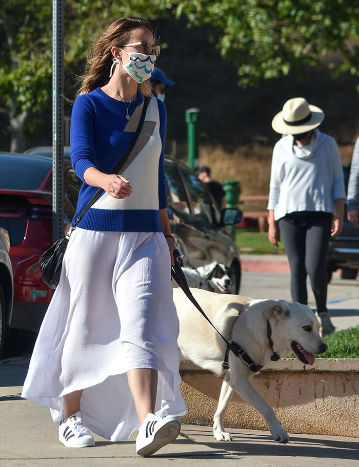 Olivia Wilde goes for a summery look in a blue sweater and white maxi skirt