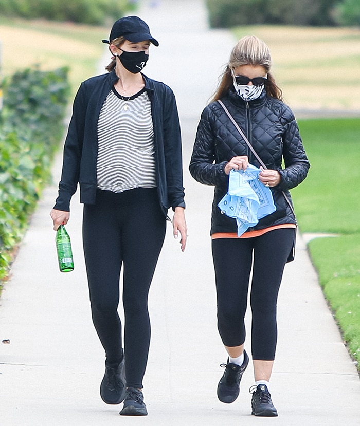 Pregnant Katherine Schwarzenegger hides her baby bump in a striped tee, a black Under Armour jacket, and black leggings