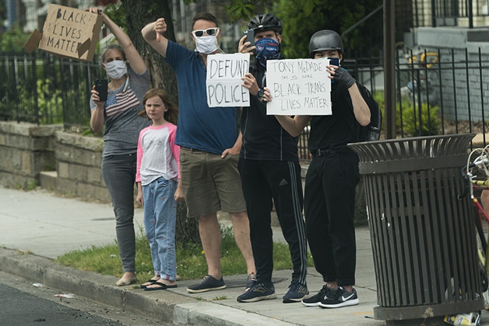 Protesters demonstrate along the route taken by Donald Trump and Melania Trump to visit the Saint John Paul II National Shrine