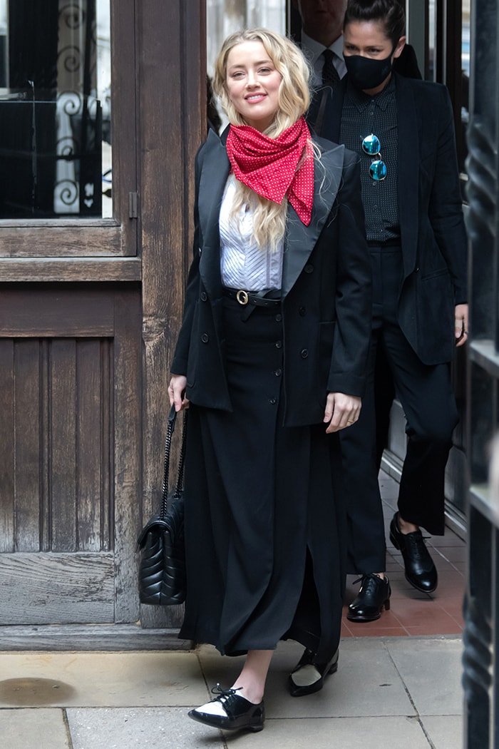 Amber Heard wears a Temperley London shirt with Joseph Maddy maxi skirt, Bella Freud jacket, and her red scarf