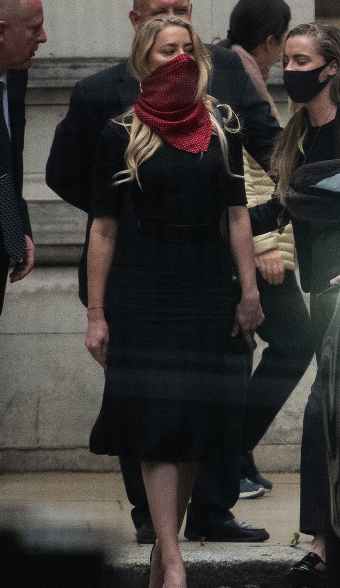 Star witness Amber Heard wears a black dress at the Royal Courts of Justice