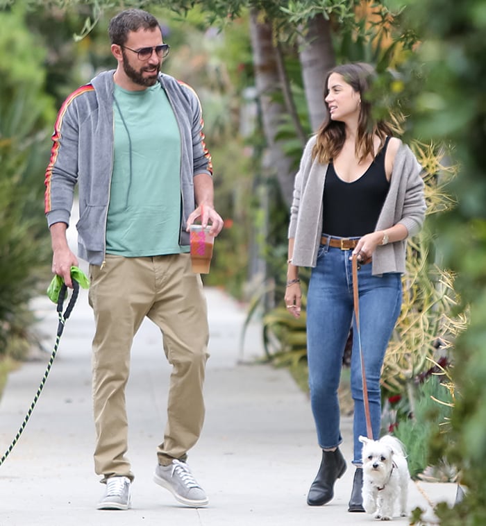 Ben Affleck wears a hooded jacket with turquoise tee and khaki pants