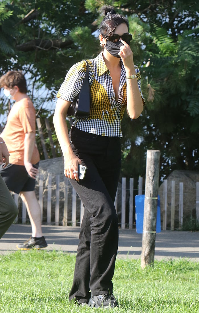 Dua Lipa wears a '90s Ottolinger gingham shirt with black slouchy pants