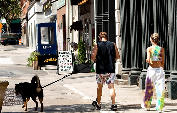 Sebastian Bear-McClard wears printed shorts with black muscle tee while Emily Ratajkowski dons a tie-dye outfit