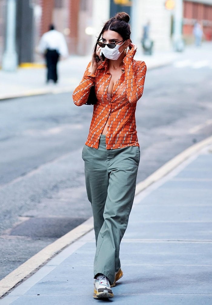 Emily Ratajkowski goes back to the '70s in funky Inamorata orange shirt and baggy green pants