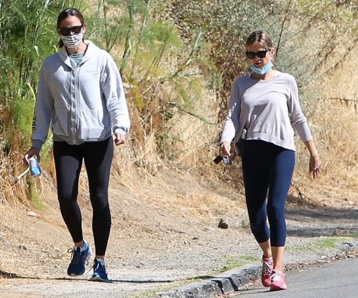 Jennifer Garner wears a protective face mask while out for a walk with a friend in Los Angeles