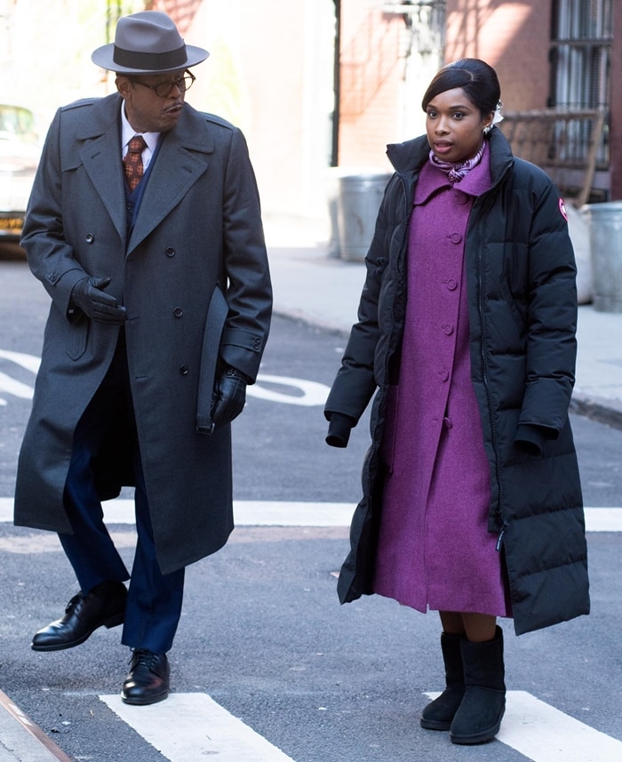 Jennifer Hudson bundles up in a long black coat and purple dress while filming a scene for Respect, walking alongside Forest Whitaker on the streets of New York
