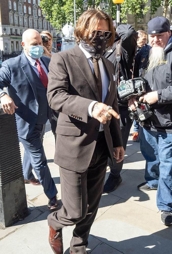 Johnny Depp wears a scarf as a face covering on the fourth day of trial against The Sun on July 10, 2020