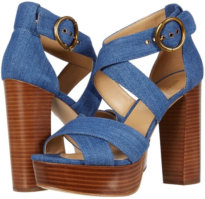This light denim platform sandal is crafted with a leather upper, and features crisscross straps, and is set on a towering wooden heel