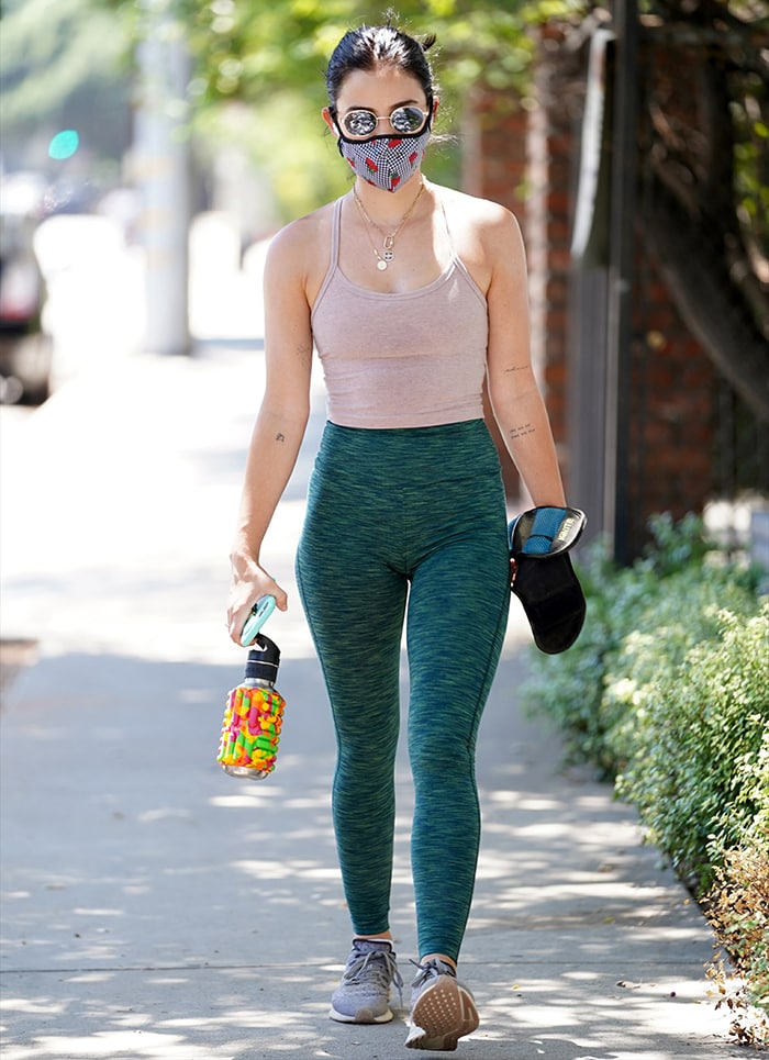 Lucy Hale wearing green Outdoor Voices Freeform hi-rise leggings goes hiking