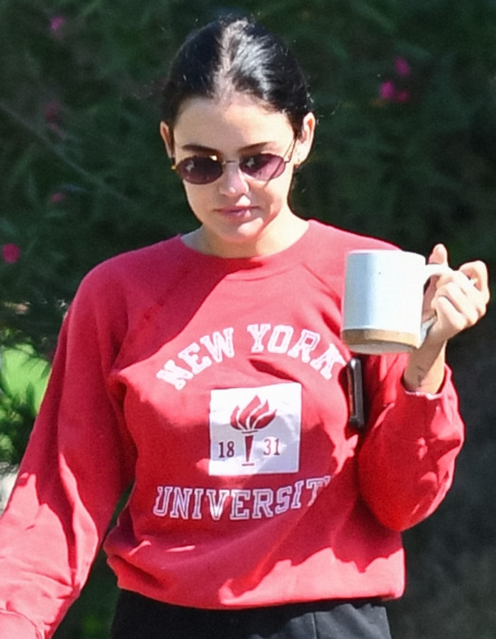 Lucy Hale steps out in red NYU sweatshirt and skips wearing a face mask