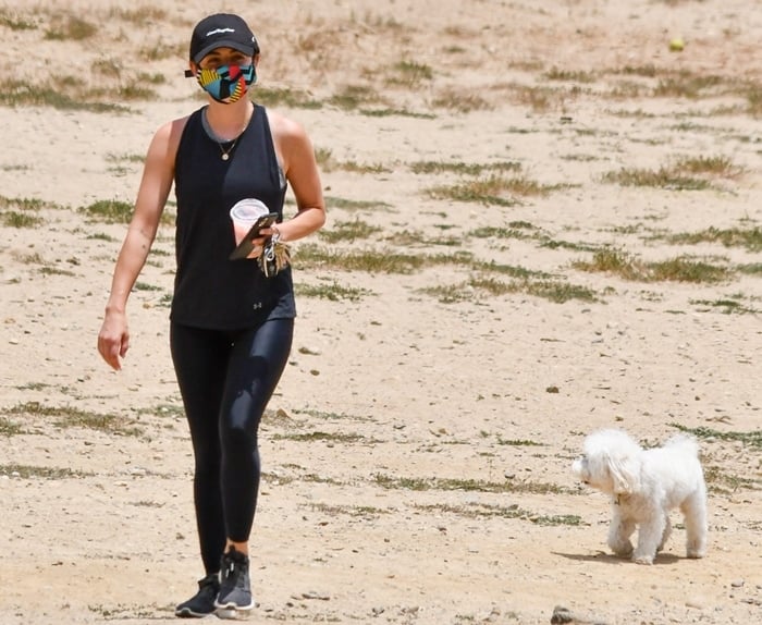 Lucy Hale wears Adidas women's Edge Lux 3 running shoes while hiking with her dog