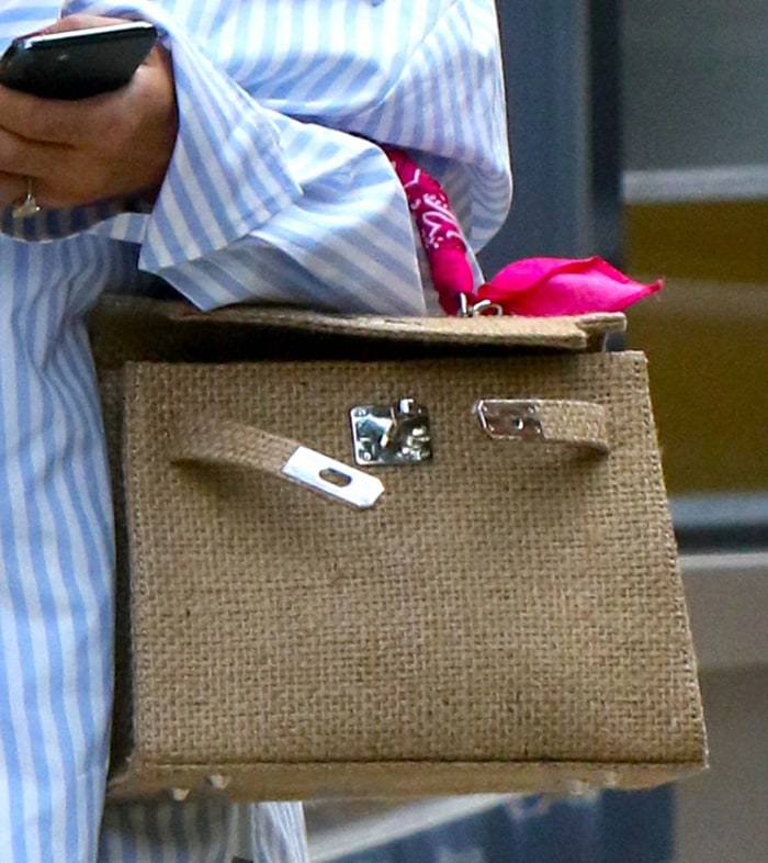 Olivia Palermo totes a Two Friends bag with pink bandana handle