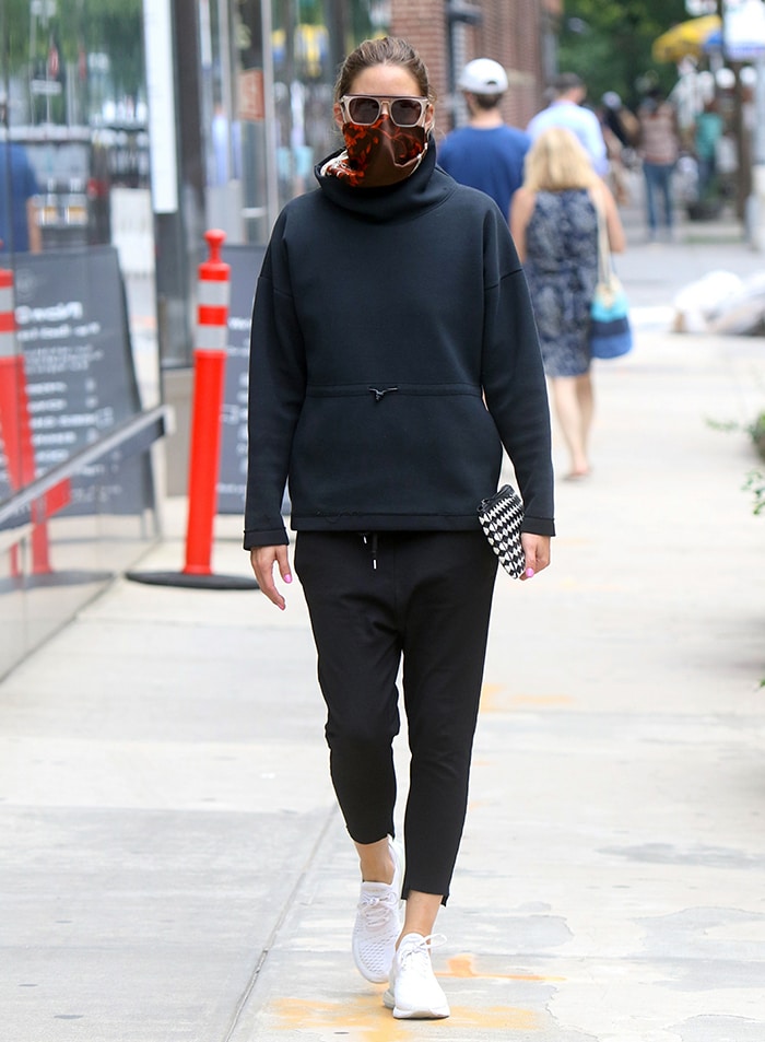 Olivia Palermo teams a black hoodie with cropped sweatpants