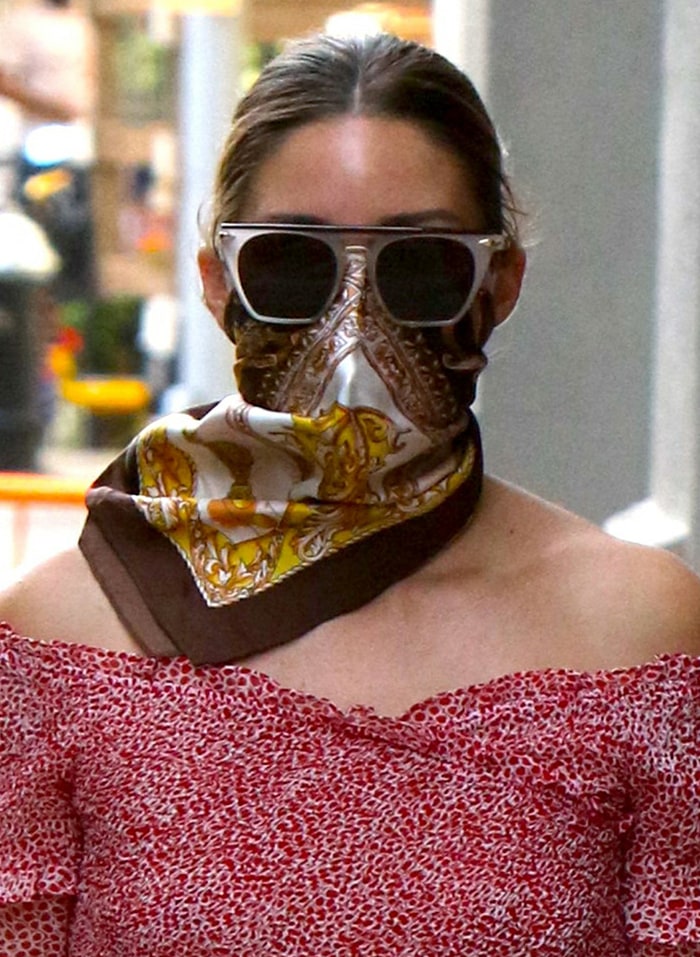 Olivia Palermo accessorizes with a printed scarf and her favorite sunglasses