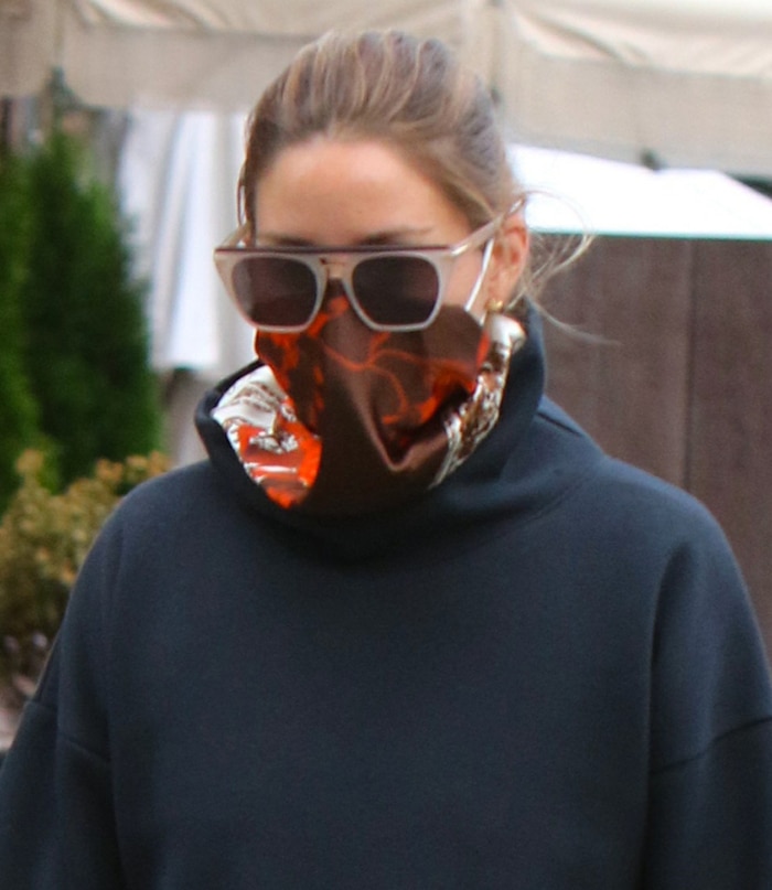 Olivia Palermo wears a red scarf as a face mask to slow down the spread of the novel coronavirus