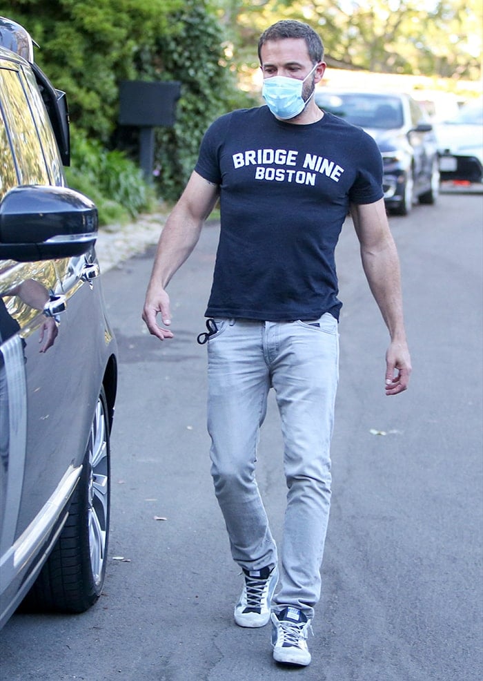 Ben Affleck pairs his black tee with gray jeans and Golden Goose high-top sneakers