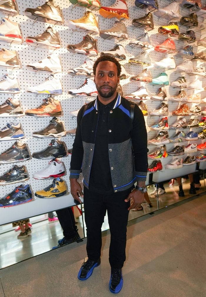 Football wide receiver Anquan Boldin checks out sneakers at Flight Club, a New York-based sneaker consignment marketplace that was acquired by GOAT in 2018