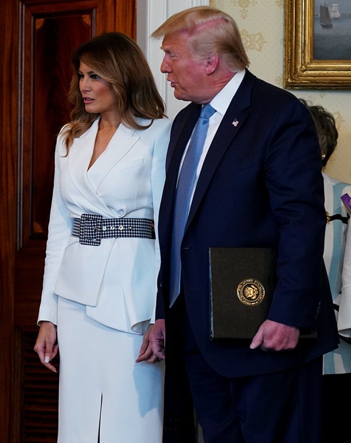 Melania Trump opts for a suffragette white look for the signing ceremony
