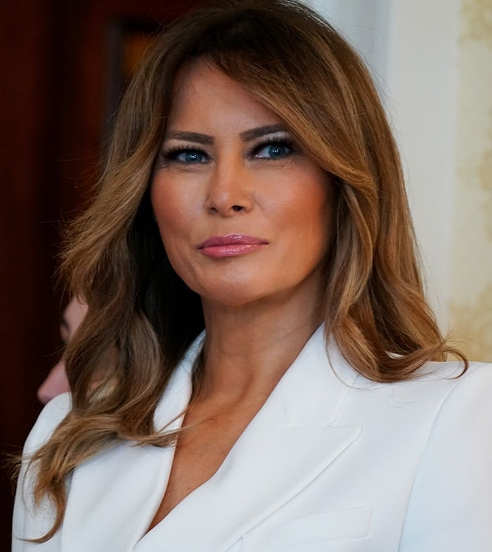 Melania Trump wears her signature smokey eye-makeup and loose brown tresses