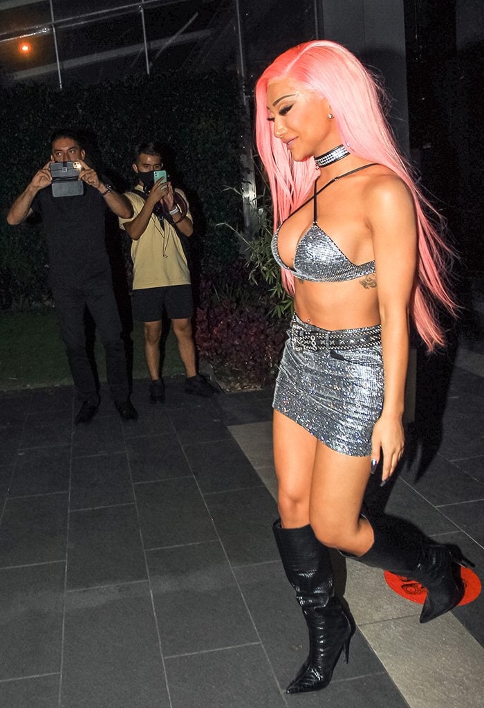 Nikita Dragun dresses in a racy embellished bra top and mini skirt