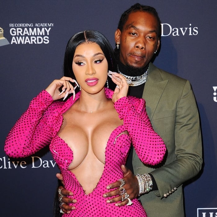Cardi B dazzles in a bold, plunging pink gown adorned with rhinestones, alongside Offset, at the Clive Davis Pre-Grammy Gala