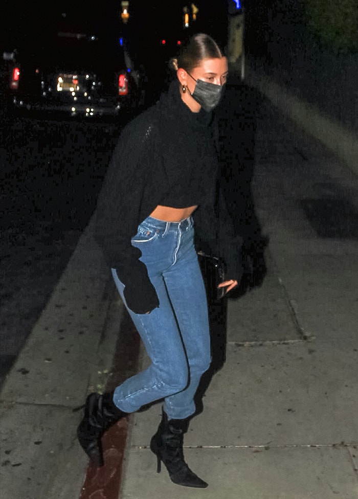 Hailey Bieber flaunts her abs in Y's black knit sweater and Levi's jeans