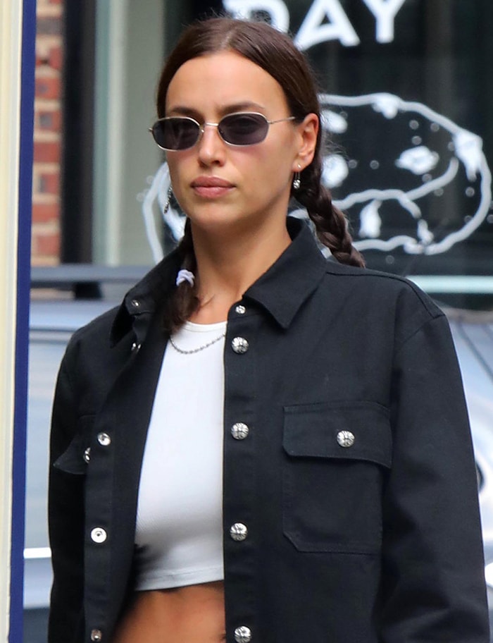 Irina Shayk wears braided pigtails and muted pink lipstick