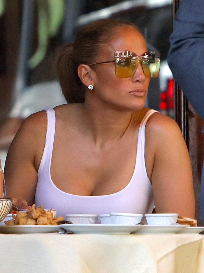 Jennifer Lopez styles her hair in a sleek ponytail with hair extensions