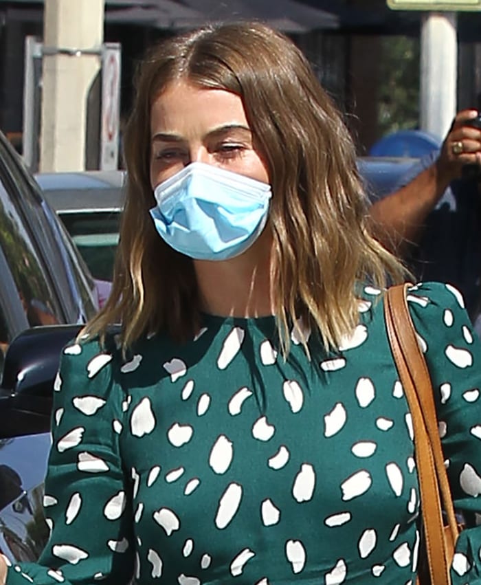 Julianne Hough wears a disposable face mask and styles her loose in natural waves