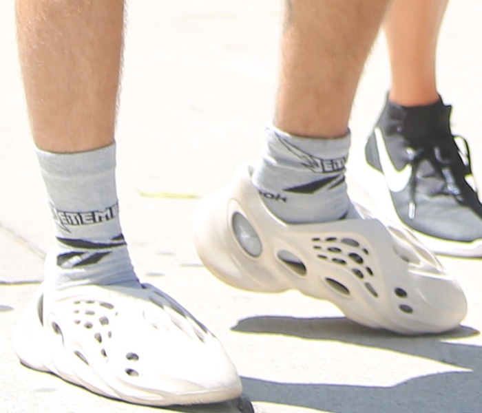 Justin Bieber wears Vetements high socks with Adidas Yeezy Foam RNNR Ararat slip-on shoes