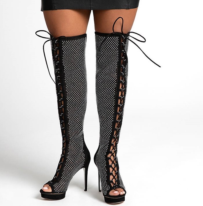 The Madia over-the-knee boot slays the style game with a powerful platform heel combo, full-length corset lacing, and see-through mesh that reveals peeks of skin