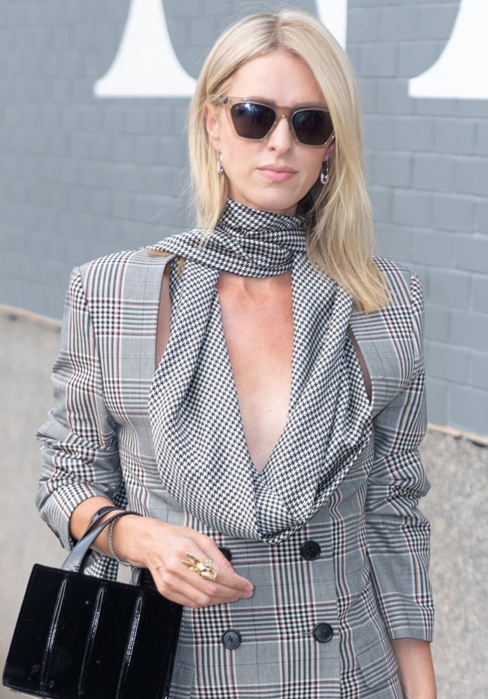 Nicky Hilton totes a timeless Max Mara Whitney leather tote with pin-tucked pleats running down the sides