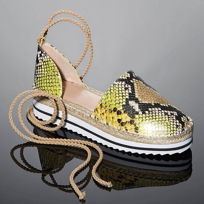 This design shows off a sporty, white-bottom sole with sawtooth treads and braided straps that wrap around the ankle