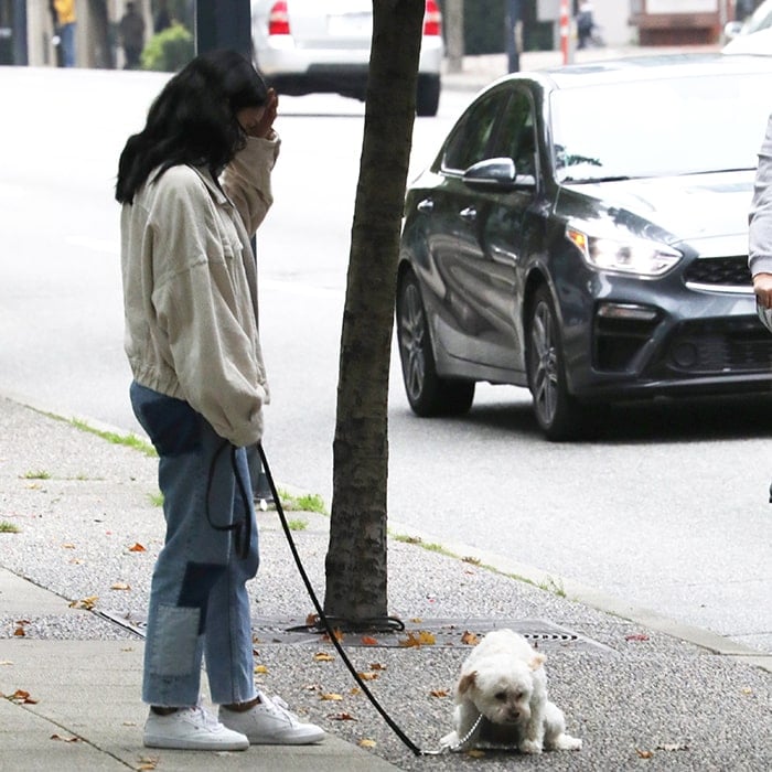 Camila Mendes bundles up in a white corduroy jacket and Maje patchwork jeans