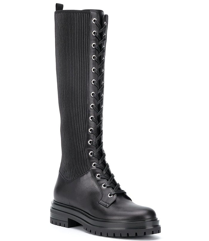 Edgy knee-high combat boots merge a smooth leather construction with rib-knit inserts