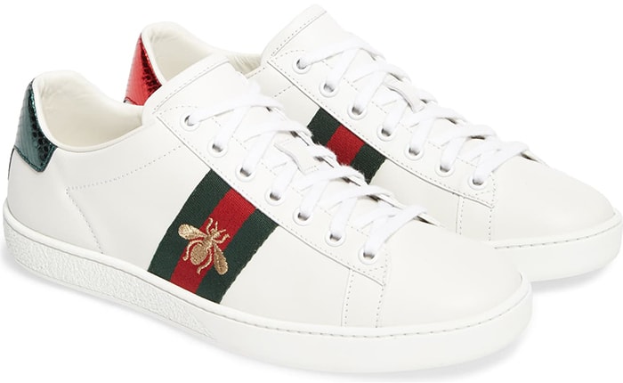 Golden bee embroidery and striped webbing bring iconic Gucci house codes to this sneaker while contrasting heel tabs reference the brand's official colors