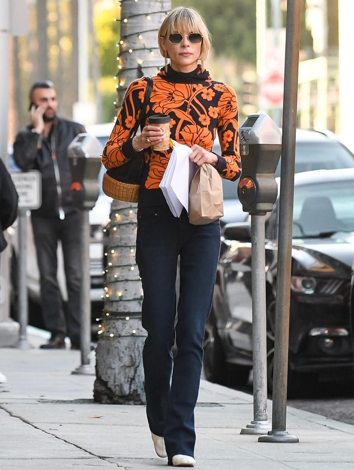 Jaime King wears a vibrant orange flower sweater