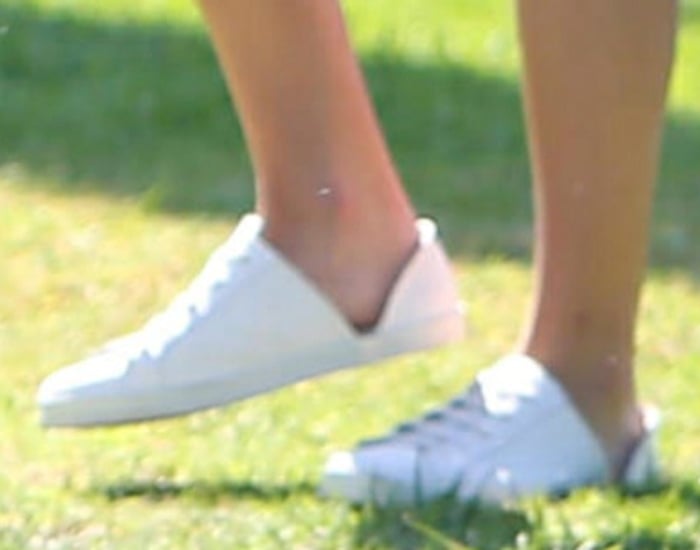 Lea Michele slips into a pair of white leather sneakers